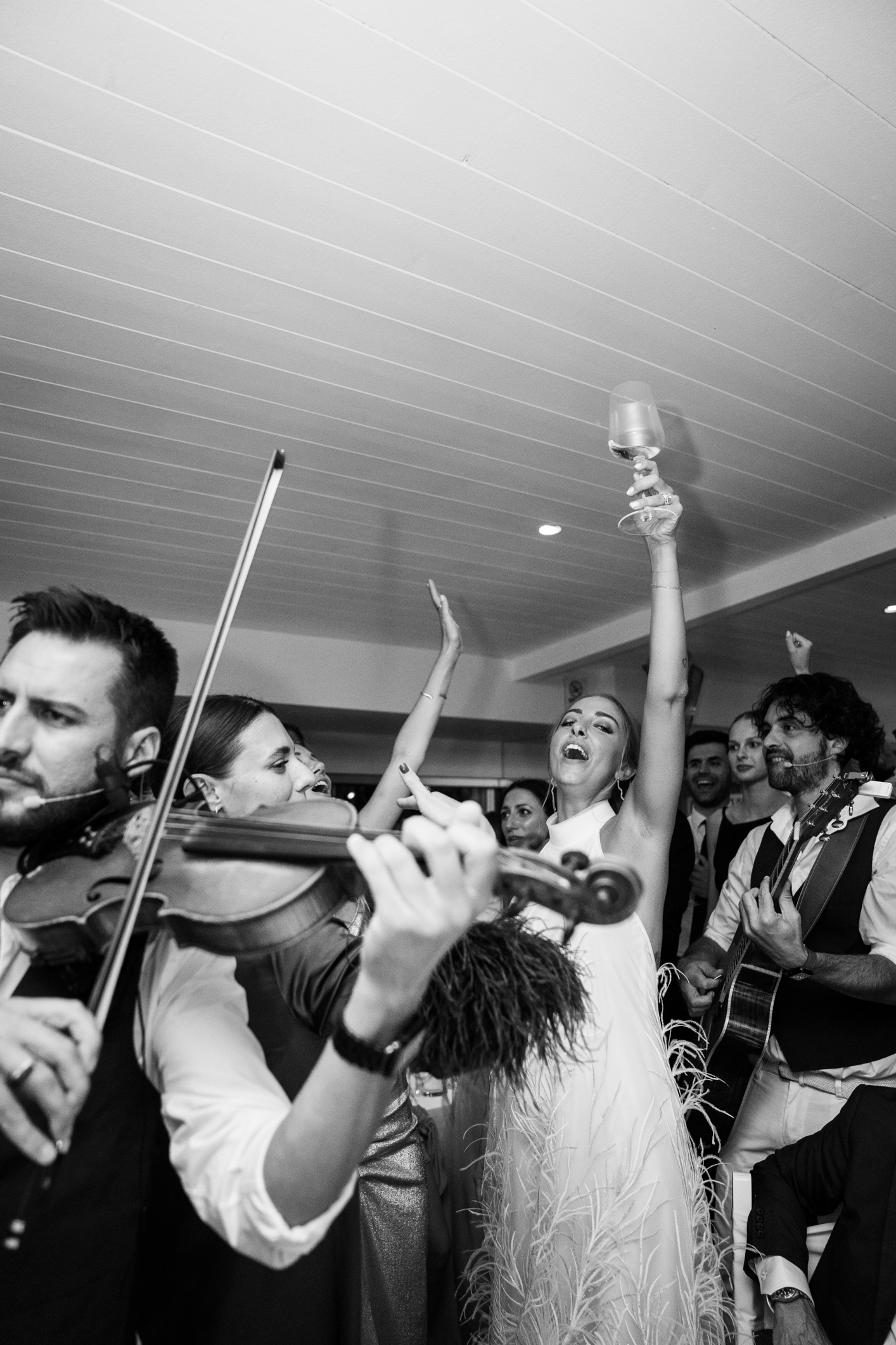 Elegant wedding in Portofino,  capturing the atmosphere of the Dolce Vita and the Italian Riviera, bride and the band dancing during the dinner in one of the most luxury venue in portofino, the Vesta Portofino by Dolce e Gabbana