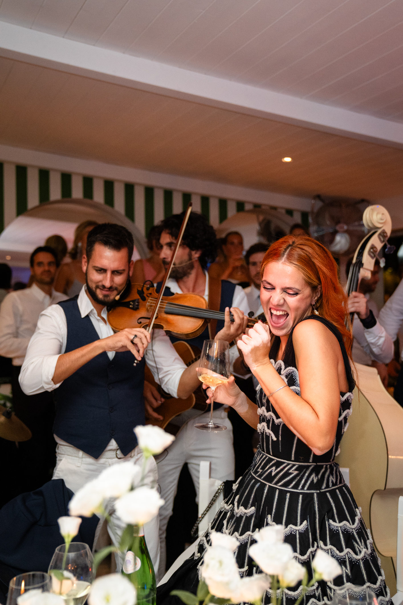 Elegant wedding in Portofino,  capturing the atmosphere of the Dolce Vita and the Italian Riviera, guest dancing during the dinner in one of the most luxury venue in portofino, the Vesta Portofino by Dolce e Gabbana