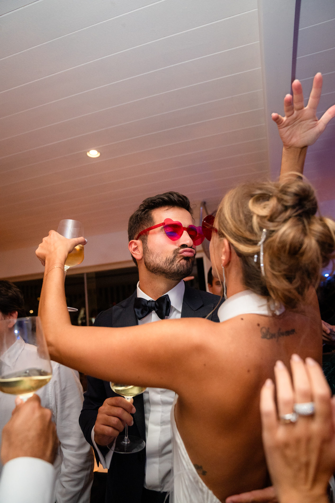 Elegant wedding in Portofino,  capturing the atmosphere of the Dolce Vita and the Italian Riviera, groom and bride dancing during the dinner in one of the most luxury venue in portofino, the Vesta Portofino by Dolce e Gabbana