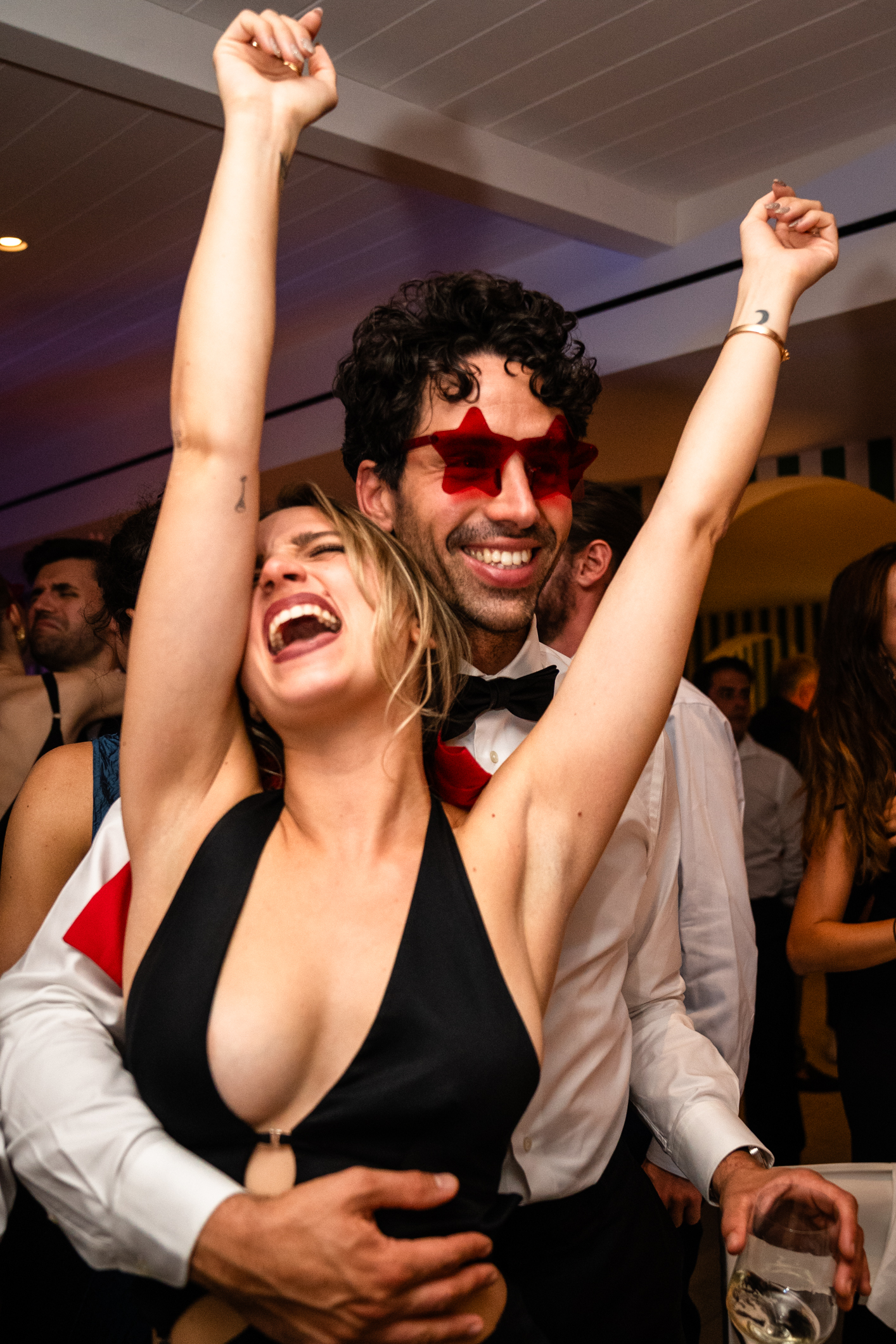 Elegant wedding in Portofino,  capturing the atmosphere of the Dolce Vita and the Italian Riviera, guests dancing during the dinner in one of the most luxury venue in portofino, the Vesta Portofino by Dolce e Gabbana