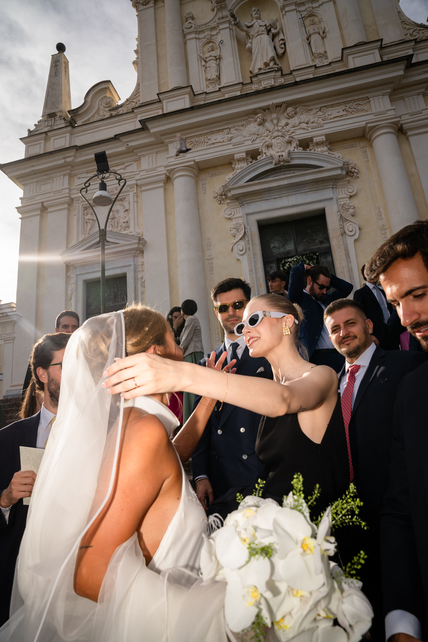 Elegant wedding in Portofino, with a view of the Ligurian bay, celebration at the historic Vesta Portofino by Dolce & Gabbana venue, capturing the atmosphere of the Dolce Vita and the Italian Riviera, bride with bouquet with guests, photo with flash