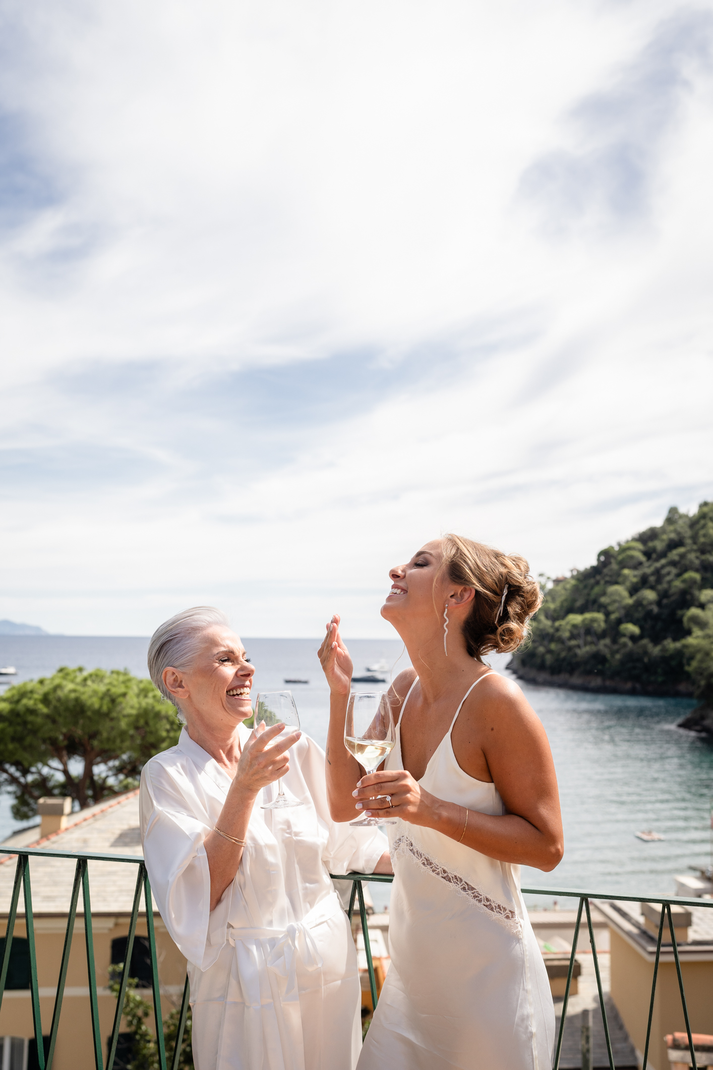 Elegant wedding in Portofino, with a view of the Ligurian bay, celebration at the historic Vesta Portofino by Dolce & Gabbana venue, capturing the atmosphere of the Dolce Vita and the Italian Riviera bride and mom with prosecco getting realdy