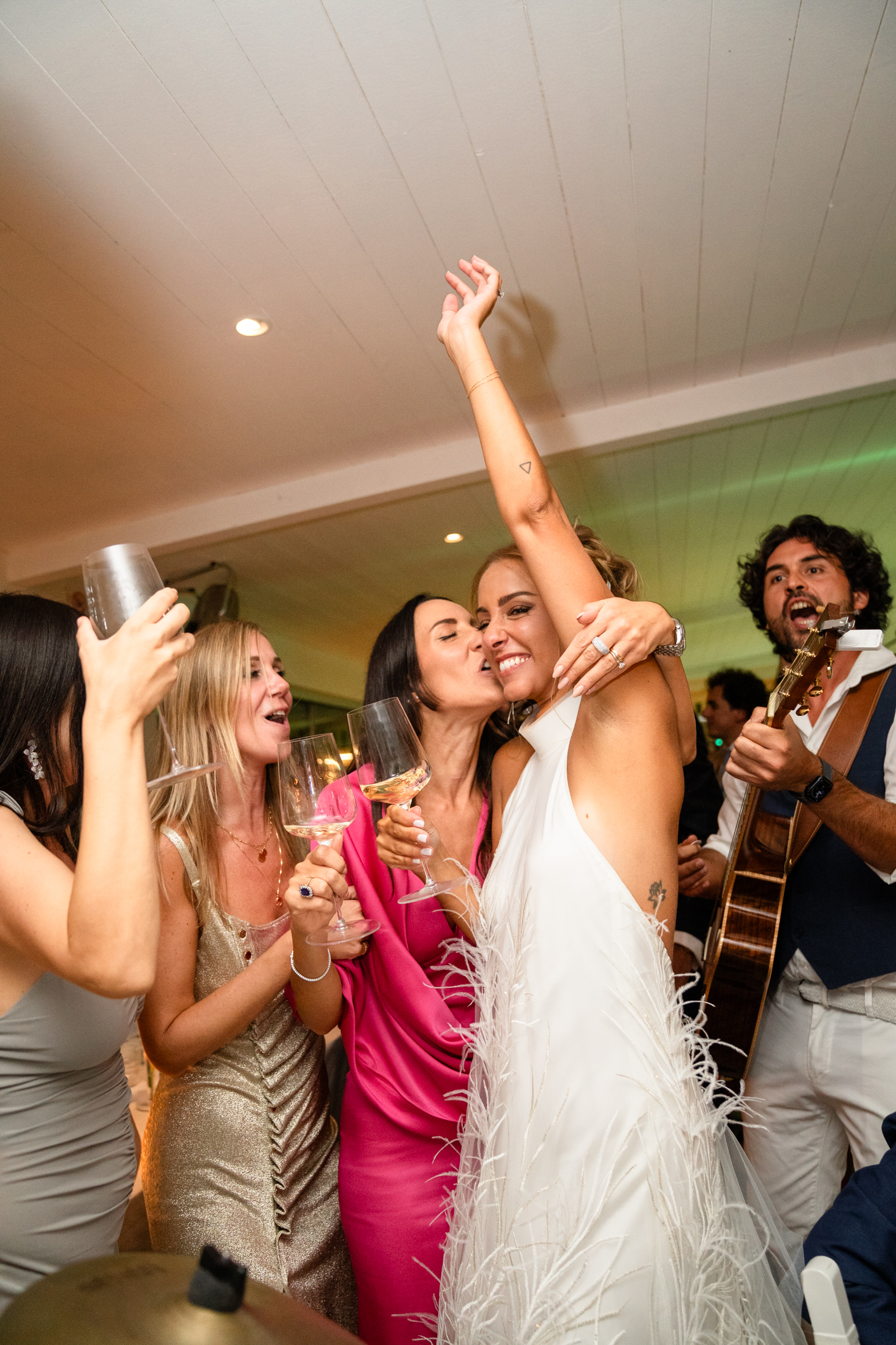 Elegant wedding in Portofino,  capturing the atmosphere of the Dolce Vita and the Italian Riviera, bride and friends dancing during dinner in one of the most luxury venue in portofino, the Vesta Portofino by Dolce e Gabbana